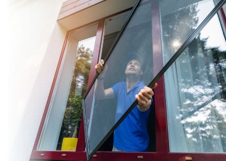 A man is installing the window glass