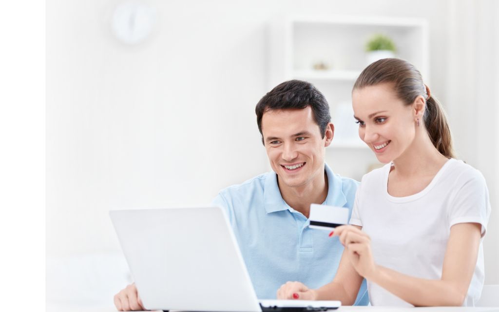 Two young man and a woman is looking at the laptop for some business